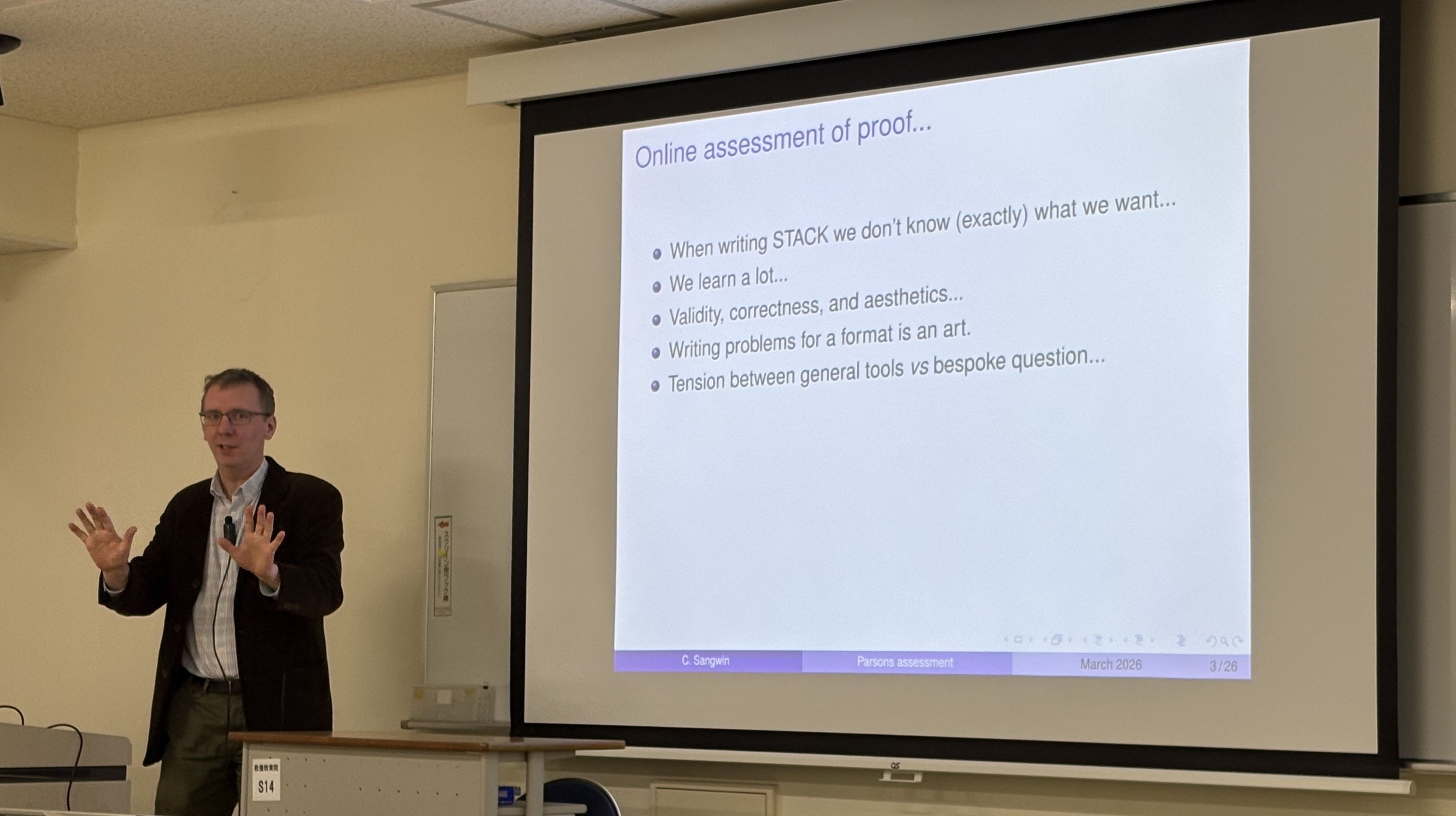 A photograph of Chris Sangwin giving a talk